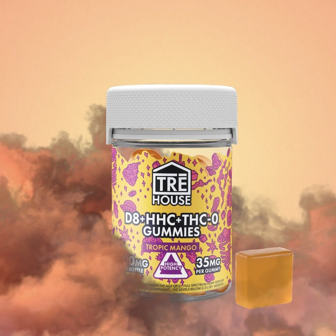 Trehouse tropical mango thc blend gummies on orange fiery background with orange and red smoke all around it.