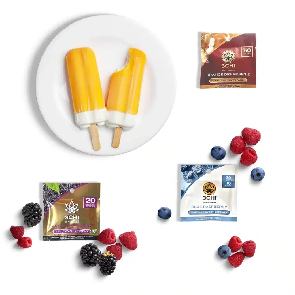 On a flat white background, you'll find three different 3chi gummy sample packs; 3chi orange dreamsicle hhc gummies, 3chi black razz d9-thc gummies, and 3chi blue raspberry thcv gummies. Next to each pack, you'll view stunning images of their real ingredients.